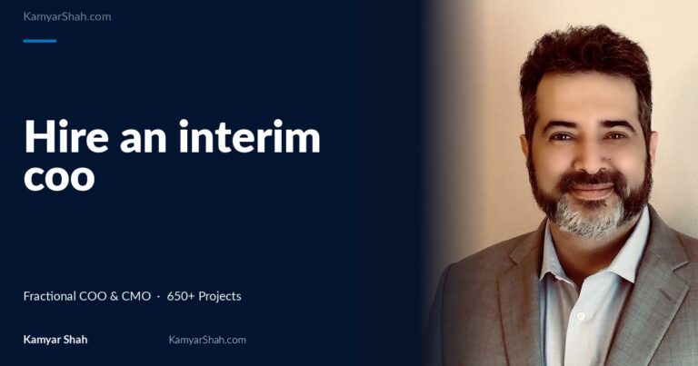 Hero banner: article title 'Hire an interim coo' on a dark blue panel beside a man in a gray suit smiling on the right.